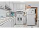 Bright kitchen featuring white appliances and cabinets with a tiled backsplash at 1502 Yaupon Dr. # A-1, Myrtle Beach, SC 29577