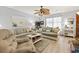 Comfortable living room featuring a ceiling fan, sofas, and beachy decor at 1502 Yaupon Dr. # A-1, Myrtle Beach, SC 29577