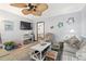 Living room featuring beachy decor, ceiling fan, a striped sofa, and television at 1502 Yaupon Dr. # A-1, Myrtle Beach, SC 29577