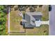 Aerial view showcases the house, back patio, and fire pit, surrounded by a lush lawn and landscaping at 1509 Osage Dr., Myrtle Beach, SC 29579