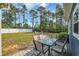 Spacious backyard with a cozy fire pit area, stylish patio furniture, and lush green grass at 1509 Osage Dr., Myrtle Beach, SC 29579