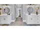 Beautiful bathroom featuring dual sinks, round mirrors, stylish lighting, and a serene gray color scheme at 1509 Osage Dr., Myrtle Beach, SC 29579