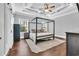 Stylish bedroom with a four-poster bed, elegant ceiling design, and hardwood floors at 1509 Osage Dr., Myrtle Beach, SC 29579