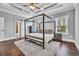 Primary bedroom with a four-poster bed, hardwood floors, and an ensuite bathroom at 1509 Osage Dr., Myrtle Beach, SC 29579