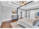 Primary bedroom featuring a four-poster bed, dresser, and hardwood floors at 1509 Osage Dr., Myrtle Beach, SC 29579