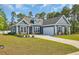 Charming blue two-story home featuring a well-manicured lawn and an attached two-car garage at 1509 Osage Dr., Myrtle Beach, SC 29579