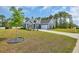 Charming blue two-story home with manicured lawn, complemented by lush trees in the background at 1509 Osage Dr., Myrtle Beach, SC 29579