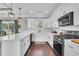 Modern kitchen with white cabinetry, stainless steel appliances, and a large island at 1509 Osage Dr., Myrtle Beach, SC 29579