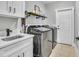 Well-organized laundry room with stainless steel washer and dryer, countertop space, and convenient shelving at 1509 Osage Dr., Myrtle Beach, SC 29579