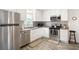 Modern kitchen with stainless steel appliances, white cabinets, and decorative backsplash at 175 Cypress Ln., Little River, SC 29566