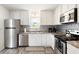 Well-lit kitchen featuring stainless steel appliances, decorative backsplash, and ample cabinet space at 175 Cypress Ln., Little River, SC 29566