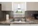 Close-up of a stainless steel kitchen sink, showcasing stylish fixtures and window view at 175 Cypress Ln., Little River, SC 29566