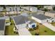 An aerial shot showcases a home with mature landscaping next to a community pond and pool creating a peaceful suburban setting at 179 S Reindeer Rd., Surfside Beach, SC 29575