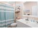 Bright bathroom with striped shower curtain and beach-themed décor creates a relaxing atmosphere at 179 S Reindeer Rd., Surfside Beach, SC 29575