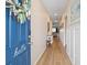 Home entryway featuring an inviting blue door, a glimpse of wood floors, and neutral walls leading to the living space at 179 S Reindeer Rd., Surfside Beach, SC 29575