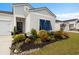 Inviting home with eye-catching blue shutters, colorful landscaping, and a welcoming entrance leading to a delightful interior at 179 S Reindeer Rd., Surfside Beach, SC 29575