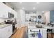 Spacious kitchen with white cabinetry, granite counters, island with seating, and stainless appliances at 179 S Reindeer Rd., Surfside Beach, SC 29575