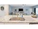 Kitchen island with a stainless steel sink overlooking the open-concept living area at 179 S Reindeer Rd., Surfside Beach, SC 29575