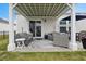 Cozy covered patio with comfortable seating and outdoor dining area at 179 S Reindeer Rd., Surfside Beach, SC 29575