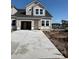 New construction home featuring neutral siding, black roof, and attached garage on a concrete driveway at 2046 Wild Indigo Circle Nw # 203, Calabash, NC 28467