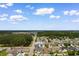 Aerial view of the home nestled in a well-planned community with lush landscaping, lakes, and amenities at 207 Cupola Dr., Longs, SC 29568