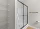 Bright bathroom featuring a glass shower, wire shelving, and neutral wall color at 207 Cupola Dr., Longs, SC 29568