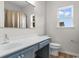 Bathroom featuring a vanity with a blue base, a mirror, and a window at 207 Cupola Dr., Longs, SC 29568