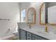 Stylish bathroom featuring double sinks, unique mirrors, and modern fixtures at 207 Cupola Dr., Longs, SC 29568