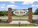 A brick community sign with a manicured landscape at the entrance, creating a welcoming atmosphere at 207 Cupola Dr., Longs, SC 29568