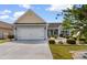 Well-maintained home with a two-car garage, driveway, and lush front yard landscaping at 207 Cupola Dr., Longs, SC 29568