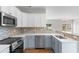 Bright kitchen with stainless steel appliances, mosaic backsplash, and an eat-in counter at 207 Cupola Dr., Longs, SC 29568