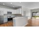 Modern kitchen with stainless steel appliances, backsplash, and breakfast bar open to the living space at 207 Cupola Dr., Longs, SC 29568
