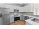 Charming kitchen with stainless steel appliances, mosaic backsplash, and a two-tone cabinet design at 207 Cupola Dr., Longs, SC 29568