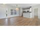 Bright, open-concept living space with wood flooring and a modern kitchen area at 207 Cupola Dr., Longs, SC 29568