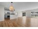 Expansive living room featuring hardwood floors, recessed lighting, and open layout to kitchen at 207 Cupola Dr., Longs, SC 29568