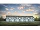 Charming exterior view of townhomes featuring light blue siding, black shutters, and well-manicured lawn at 330 Bayou Loop # Lot 68, Surfside Beach, SC 29575