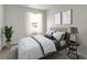 Bright bedroom featuring a plush bed, neutral walls, modern art, and a large window at 332 Bayou Loop # Lot 69, Surfside Beach, SC 29575