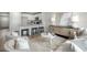 Inviting living room featuring a kitchen island, bar stools, neutral decor, and ample seating at 332 Bayou Loop # Lot 69, Surfside Beach, SC 29575