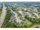 Aerial view of a suburban community highlighting houses, natural pond, and lush landscaping at 349 N Bar Ct., Myrtle Beach, SC 29579