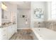 Luxurious bathroom with soaking tub, double vanity, granite countertop, and elegant finishes at 349 N Bar Ct., Myrtle Beach, SC 29579
