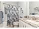 Well-lit bathroom with a shower, granite countertop, and white cabinets at 349 N Bar Ct., Myrtle Beach, SC 29579