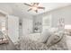 Bright bedroom featuring a ceiling fan, closet, and white floral bedding at 349 N Bar Ct., Myrtle Beach, SC 29579