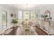 Bright dining room with a bay window, chandelier, hardwood floors, and stylish furniture at 349 N Bar Ct., Myrtle Beach, SC 29579