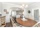 Open dining room with hardwood floors and a view of the adjacent kitchen and living area at 349 N Bar Ct., Myrtle Beach, SC 29579