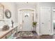Welcoming entryway with hardwood floors, a decorative wreath, and an arched transom window above the door at 349 N Bar Ct., Myrtle Beach, SC 29579