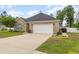 Attractive brick home with a two-car garage, lush landscaping, and a well-kept lawn at 349 N Bar Ct., Myrtle Beach, SC 29579