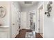 Entry hallway featuring hardwood floors, white doors, and decorative wall accents leading into the home's interior at 349 N Bar Ct., Myrtle Beach, SC 29579