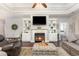 Comfortable living room with a fireplace, built-in shelves, and dark hardwood flooring at 349 N Bar Ct., Myrtle Beach, SC 29579