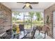 Screened porch with ceiling fan, brick walls and outdoor seating at 349 N Bar Ct., Myrtle Beach, SC 29579