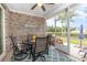 Screened porch with ceiling fan, brick walls and outdoor seating at 349 N Bar Ct., Myrtle Beach, SC 29579